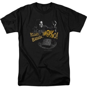 May include: Black t-shirt with a graphic of a man in a yellow shirt holding a stone and the text "Klaatu... Barada... N#@%@%O!"