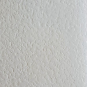 May include: Textured ivory-coloured surface with the words "ivory hammer" in a dark font at the top. The surface has a rough, uneven appearance, with a subtle, off-white hue.