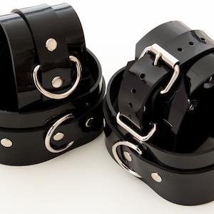 Hand and ankle cuffs made of colored PVC bondage set latex