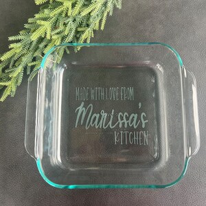 May include: A clear glass baking dish with the text "Made with love from Marissa's Kitchen" etched into the bottom.