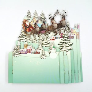 Carte de voeux de Noël 3D pop-up du père Noël sur un traîneau avec des rennes