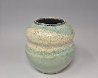 Handmade, earthy green ceramic vase with soft curves and shiny finish