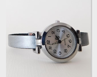 Women's wristwatch, custom-sized leather band, magnetic clasp.