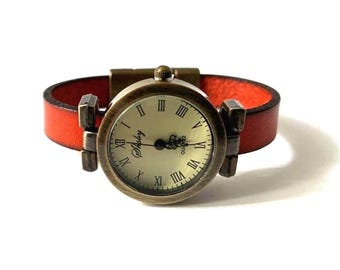 Wristwatch for women with a custom-sized burn orange leather band and a magnetic clasp.