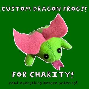 May include: A handmade plush dragon frog in green and pink, with black button eyes and a pink tongue. The image includes the text "CUSTOM DRAGON FROGS!" and "FOR CHARITY!" on a green background. The text also says "read everything before ordering!"