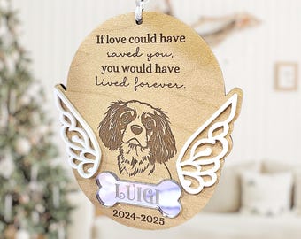 May include: A wooden pet memorial ornament featuring a dog portrait, angel wings, and the name "Luigi" on a bone-shaped tag. The ornament includes the text "If love could have saved you, you would have lived forever." and the years 2024-2025.