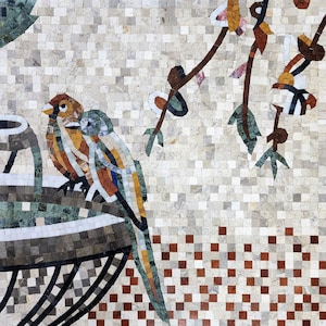 May include: A mosaic tile artwork featuring a colorful bird perched on a black metal planter. The background is a white mosaic with a brown and white checkered pattern at the bottom. The bird is surrounded by a green and brown mosaic floral design.