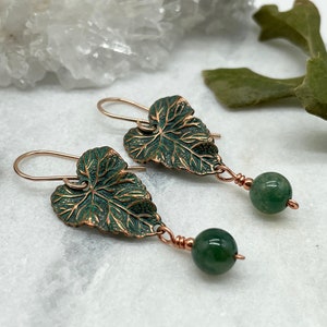 May include: A pair of green leaf earrings with copper wire and green gemstone beads.