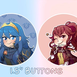 May include: Two 1.5 inch button designs featuring anime characters. The first button is blue and features a female character with blue hair and a crown. The second button is pink and features a female character with red hair and a ponytail. The text "1.5" BUTTONS" is printed below the buttons.