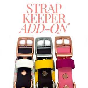 May include: Three dog collars with different coloured straps and buckles. The collars are pink, yellow, and white. The buckles are rose gold, silver, and rose gold. The text "STRAP KEEPER ADD-ON" is at the top of the image.