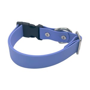 May include: A light blue dog collar with a black plastic buckle and a silver-colored metal D-ring and buckle. The collar is made of a flexible, waterproof material.