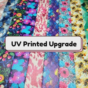 May include: A collection of vertical strips featuring diverse patterns including floral, marble, animal print, mermaid scales, bees, and mountain landscapes, with a central rectangular label displaying the text UV Printed Upgrade.