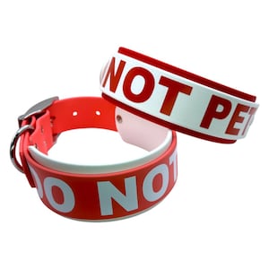 May include: Two red dog collars with white lettering. The top collar says "Do Not Pet" and the bottom collar says "Do Not Pet".