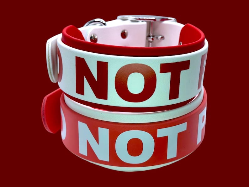 May include: Two red and white dog collars with the text "NOT FOR" printed on them.