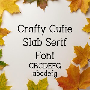 May include: A white background with the text "Crafty Cutie Slab Serif Font" in black. The letters "ABCDEFG" and "abcdefg" are displayed below the word "Font". The image is framed by yellow and brown autumn leaves.