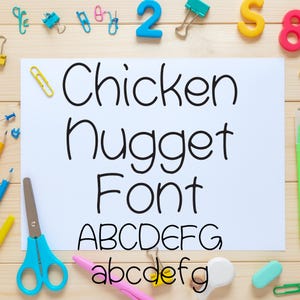 May include: A white sheet of paper with the words "Chicken Nugget Font" in black, handwritten-style lettering. Below the title are the uppercase and lowercase alphabets. The paper is surrounded by school supplies, including scissors, paper clips, and erasers.