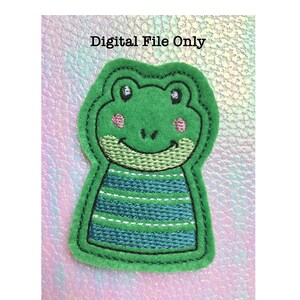 May include: A green felt frog applique with a smiling face, pink cheeks, and a blue and white striped shirt. The applique is outlined in black stitching. Text at the top reads "Digital File Only".
