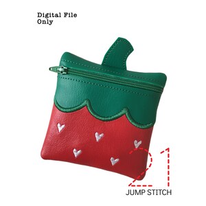May include: A green and red strawberry-shaped zippered pouch with white embroidered hearts. The pouch has a jump stitch detail.