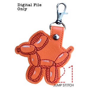 May include: Orange balloon dog keychain with a silver jump ring. The keychain is approximately 2 inches tall.  The balloon dog is embroidered with white stitching.  The text "JUMP STITCH" is printed below the keychain.