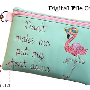 May include: A teal zippered pouch with a pink flamingo wearing sunglasses and the text "Don't make me put my foot down".