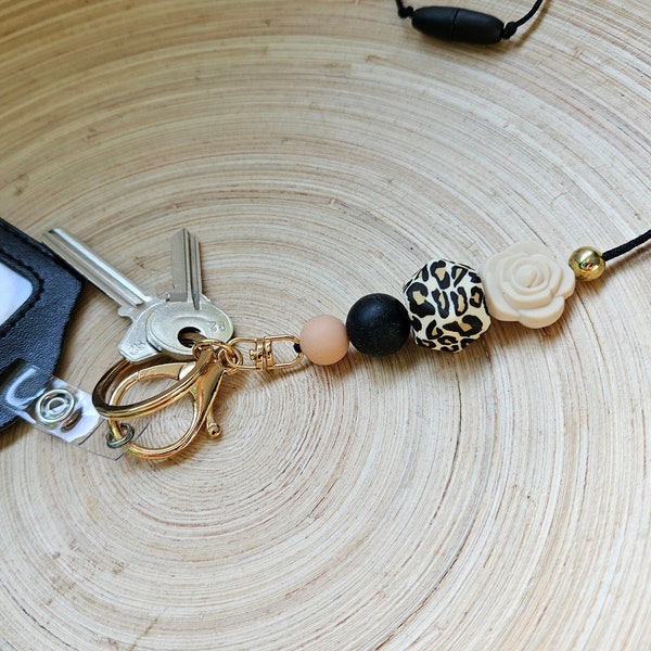 Exotic flower, easy to wear lanyard. Silicone beaded, classroom and office safe. Gold and leopard print.