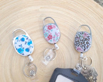 Retractable reel for key ring & badge holder. Flowery pink, red, blue colors. Butterflies. Attach to belt loop, lanyard, etc