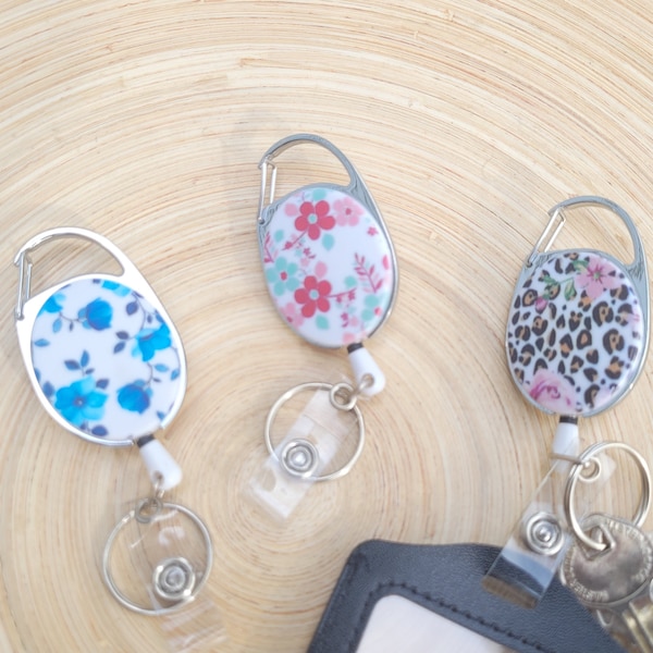 Retractable reel for key ring & badge holder. Flowery pink, red, blue colors. Butterflies. Attach to belt loop, lanyard, etc