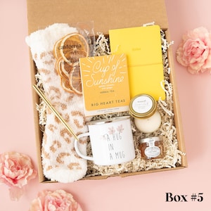 a box with a cup, mug, and other items