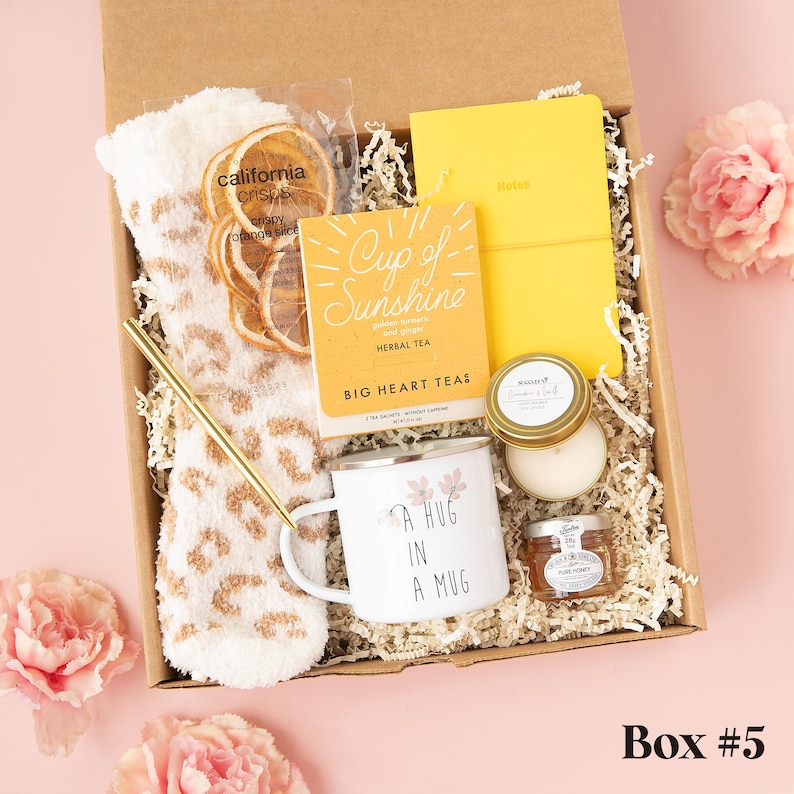 a box with a cup, mug, and other items