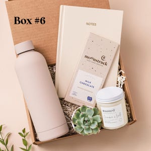 a box containing a bottle of coffee, a container of cream and a box of