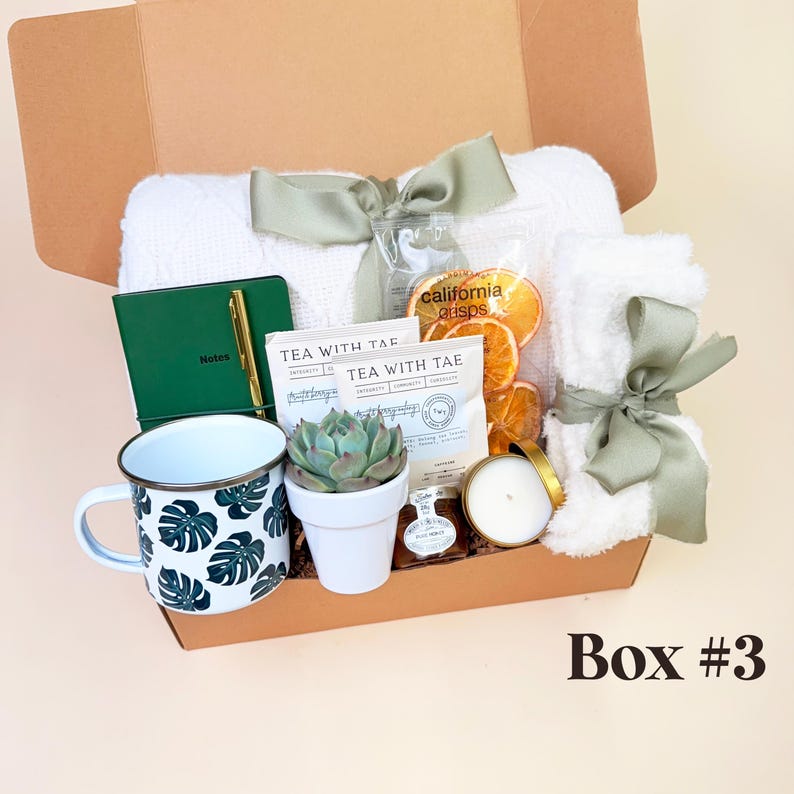 a box with a cup, mug, tea bag and other items