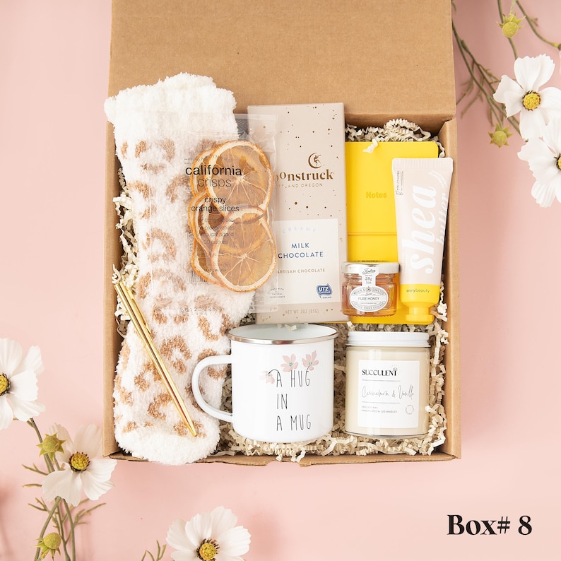 a box with a cup, a mug, a towel, and some other items