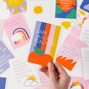 May include: A pink and yellow affirmation card with a rainbow and the text "The work I do matters".