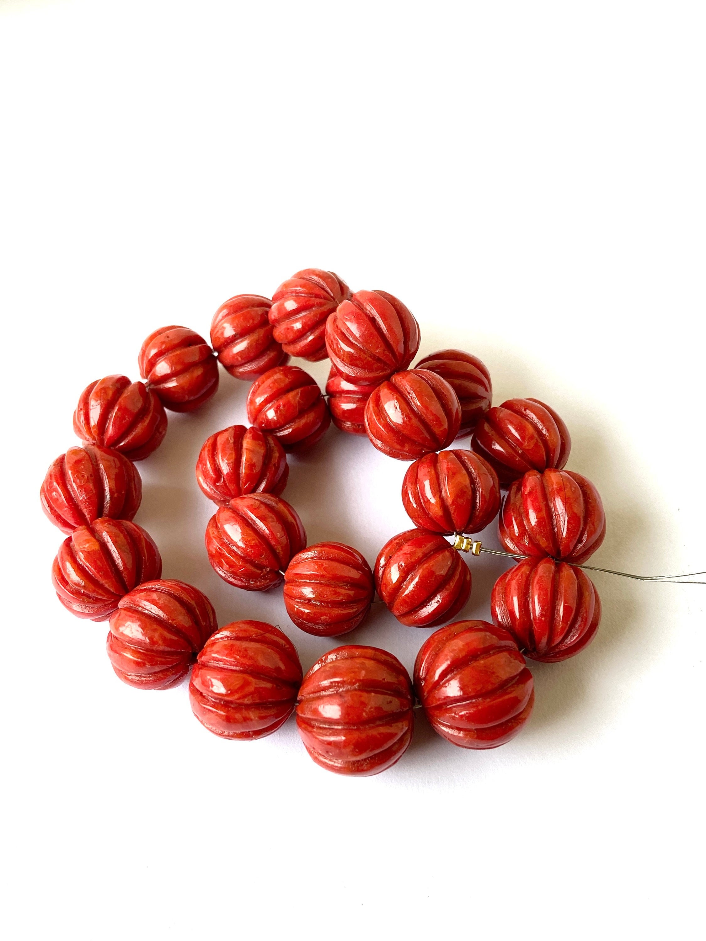 Carved red coral beads discount