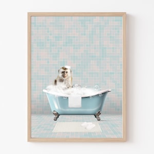 May include: A white monkey with brown fur sits in a blue bathtub with white bubbles. The bathtub has silver feet and is on a white and blue tiled floor. A white towel is in the bathtub and white flip flops are on the floor.