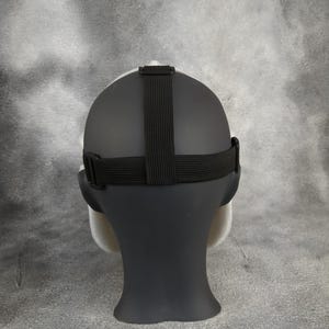May include: A white and black mask with an adjustable strap. The mask is made of a smooth, flexible material and has a realistic appearance.