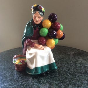 Royal Doulton The Old Balloon Seller HN1315 Measures 7.75”  Excellent used condition.