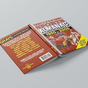 May include: A red and white book titled "Gray's Sports Almanac 1950-2000" with a picture of athletes playing various sports on the cover. The back cover lists sports covered in the book, including football, baseball, hockey, golf, tennis, and more.