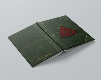 May include: A green book with a gold spine and a red and gold Celtic knot design on the cover. The book is open to a page that says "First Lessons".