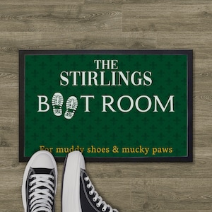 May include: A green doormat with a white border and the text "The Stirlings Boot Room" in white. The doormat also has a green and white floral pattern and the text "For muddy shoes & mucky paws" in yellow.