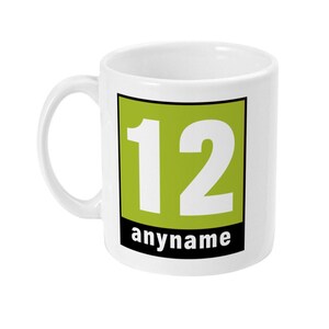 May include: White ceramic mug with a green square featuring the number 12 in white text. The text "anyname" is printed below the square.