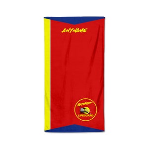 May include: A red beach towel with yellow and blue accents. The towel features the text "ANYNAME" in yellow, and a "Baywatch Lifeguard" logo in a yellow circle at the bottom. The towel is rectangular.