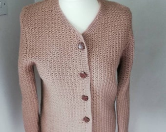 Hand knitted vintage woollen fitted cardigan in very good condition. It is a pale maroon colour.