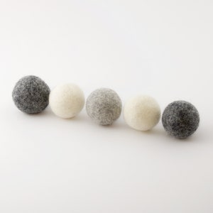 Five natural wool balls in three different colors for cat lovers to put under the christmas tree