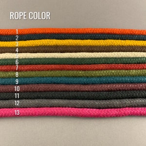May include: A chart showing 13 different colors of rope. The rope colors are: orange, yellow, brown, beige, red, green, teal, maroon, black, gray, and pink. The chart is labeled "ROPE COLOR" and each color is numbered 1 through 13.
