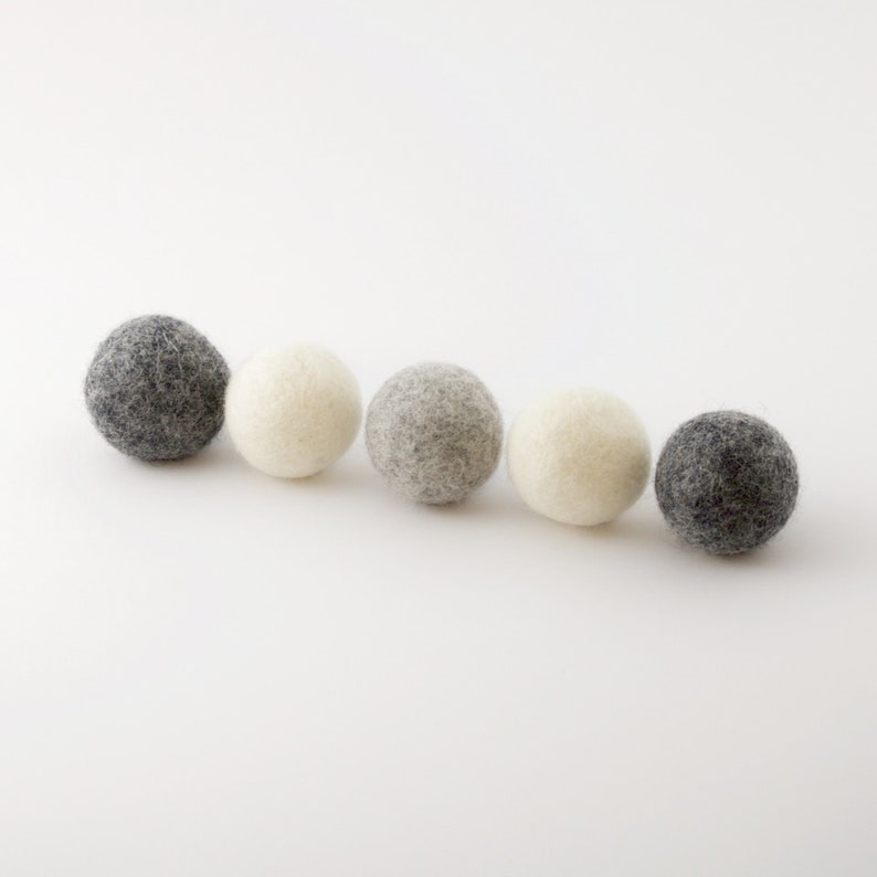 Five natural wool balls in three different colors for cat lovers to put under the christmas tree