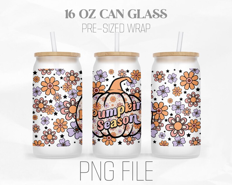 May include: A white 16 ounce can glass with a pre-sized wrap featuring a pumpkin with the text "Pumpkin Season" and a floral pattern in shades of orange, pink, and purple.