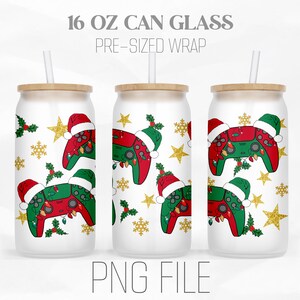 May include: Three 16 oz can glasses with a Christmas themed design featuring a video game controller, holly, snowflakes, and gold stars. The text "16 OZ CAN GLASS" and "PRE-SIZED WRAP" is at the top of the image. The text "PNG FILE" is at the bottom of the image.