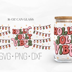 May include: A 16 oz glass can with a design of a string of Christmas lights and the text "HOLLY JOLLY VIBES" in pink, green, and red. The text is in a retro font style.