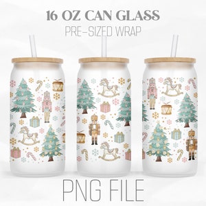 May include: Three 473 ml can glasses with a pre-sized wrap featuring a Christmas-themed pattern. The design includes Christmas trees, nutcrackers, rocking horses, gifts, and candy canes in pastel colours. Each glass has a bamboo lid and a straw.